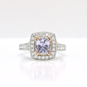 Cushion Cut Lilac Sapphire Set in a Rose and White Gold Diamond Halo Design