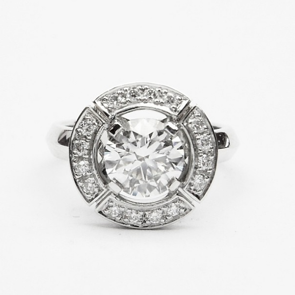 Round Brilliant Cut Diamond in a Grain Set Segmented Halo Design Ring