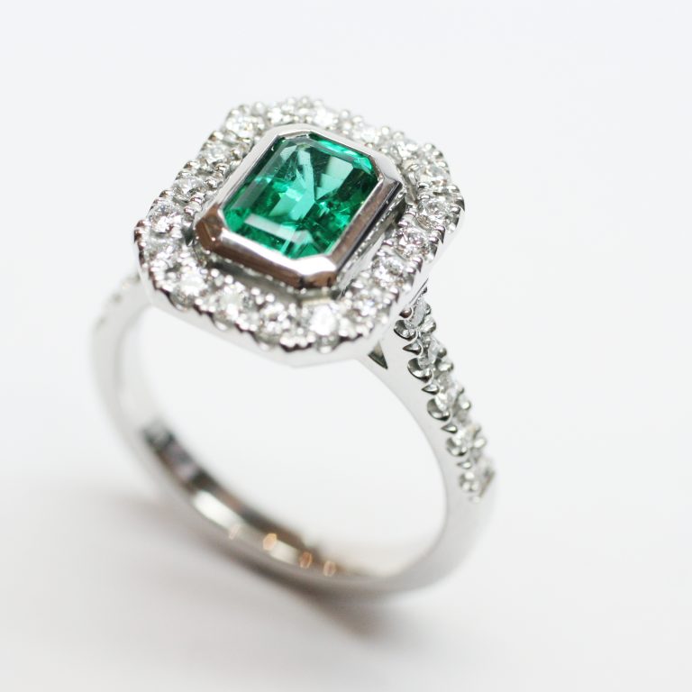 Colombian Emerald Bezel Set in a White Gold and Diamond Halo Design Ring