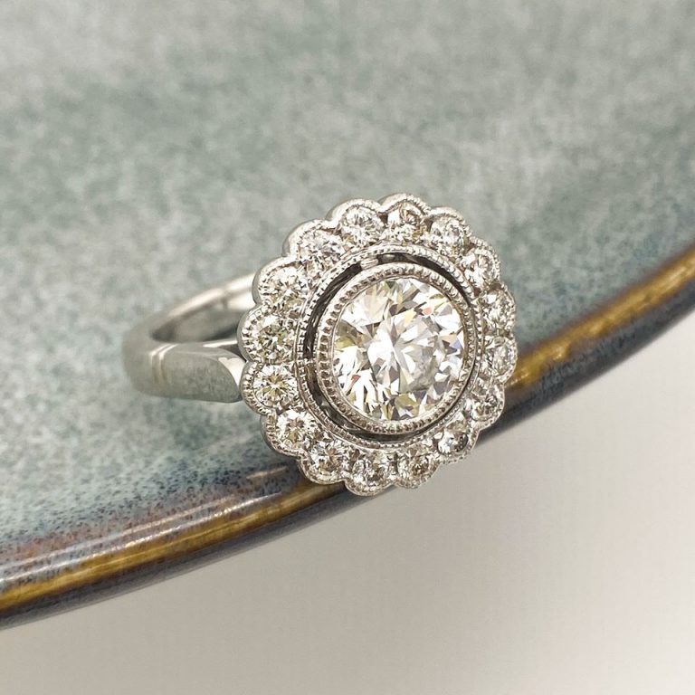 Round Brilliant Cut Diamond Vintage Inspired Halo Design Featuring Mill Grain