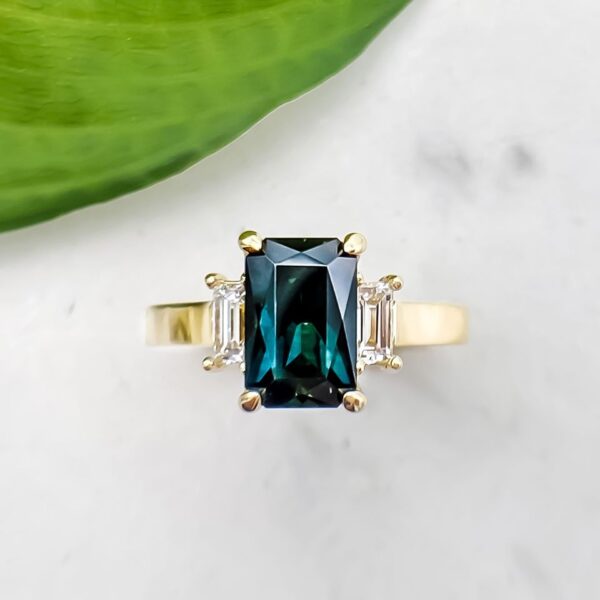 Radiant Cut Teal Sapphire and Baguette Diamond Three Stone Ring