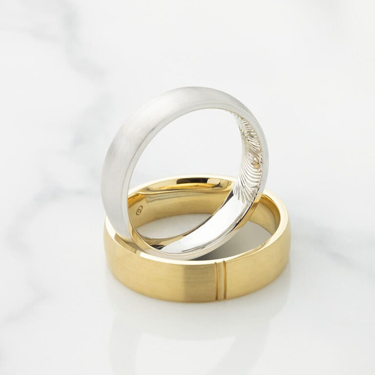 Men's white and yellow gold wedding rings with fingerprint engraving