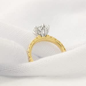 Yellow gold diamond engagement ring with platinum tulip-style claws