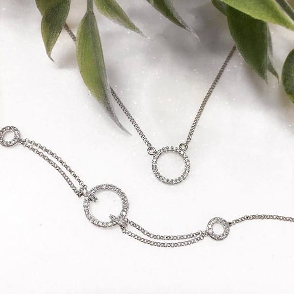 Delicate bespoke diamond bracelett and necklace with circular pendant