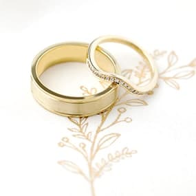 Yellow Gold brushed metal and curved diamond wedding rings handmade in a make your own wedding ring workshop.