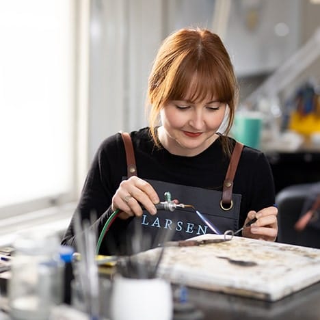 A Larsen Jeweller carefully creating a bespoke wedding ring out of white gold.