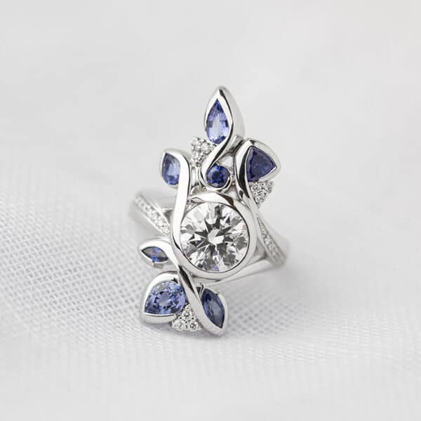 Round Brilliant Cut Diamond Ring Featuring Sapphire and Diamond Accents