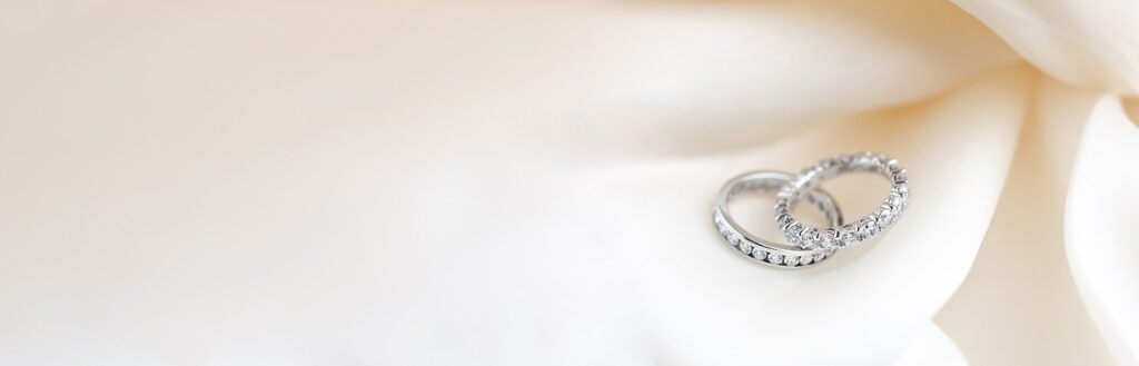 A pair of bespoke, handcrafted eternity rings featuring diamonds set in white gold