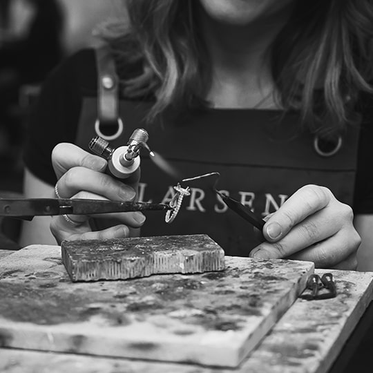 A senior jeweller at Larsen creating a bespoke dress ring in the studio