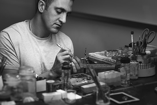 An expert jeweller creating a custom eternity ring in our local jewellery studio