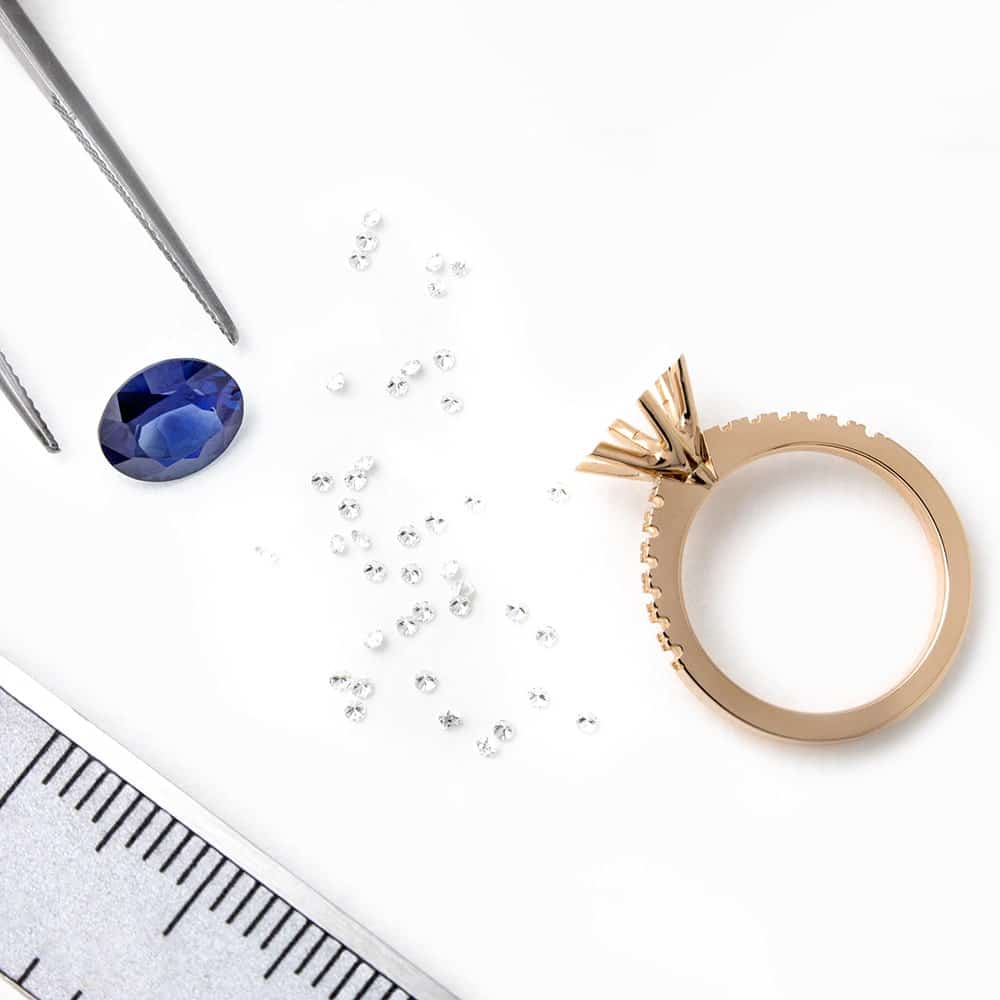 An Engagement ring in the workshop ready to be set with a Sapphire and side diamonds