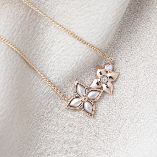 Rose and White Gold Flower Necklace with a Bezel Set Diamond