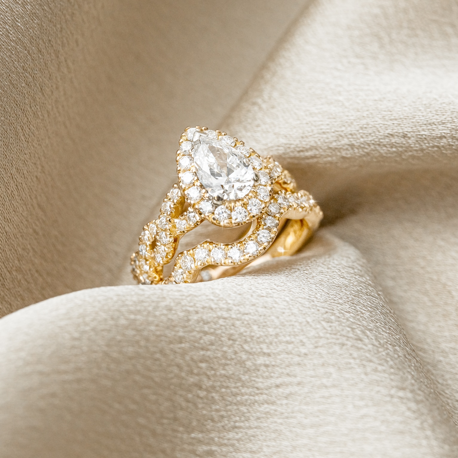 Pear Diamond Halo Engagement Ring with Intertwined Diamond