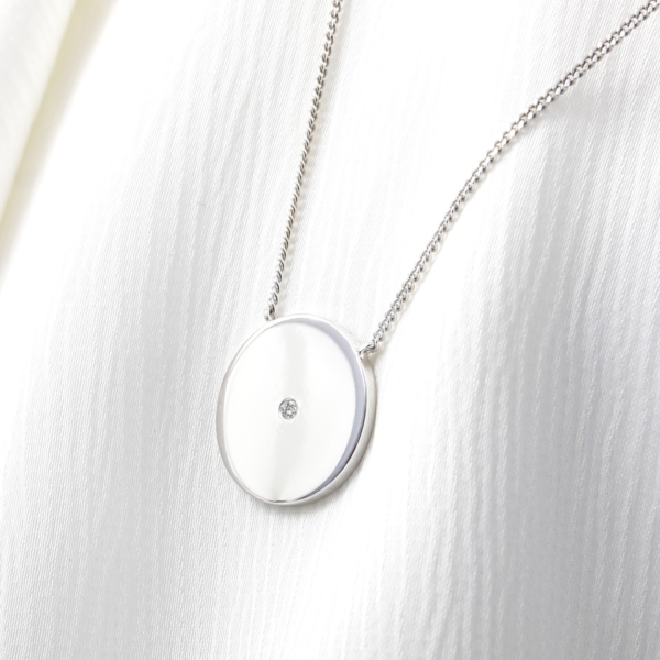 White Gold Disc Pendant with a Flush Set Diamond