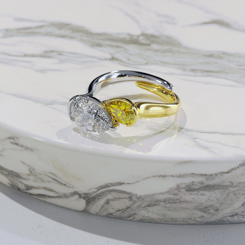 A toi et moi engagement ring featuring yellow and white pear shaped diamonds