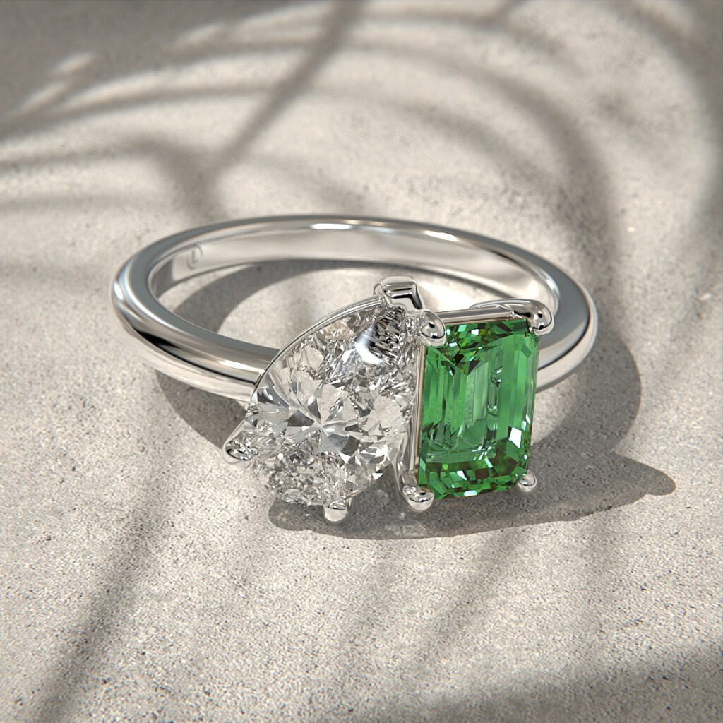 A toi et moi engagement ring pear shaped diamond and an emerald cut