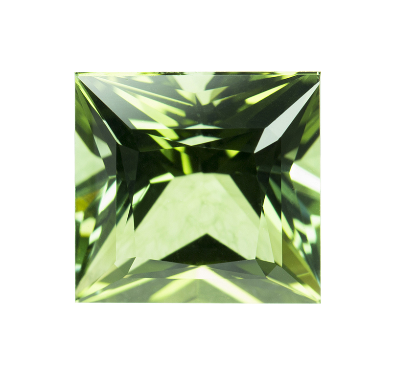 Tsavorite green gemstone on a white background