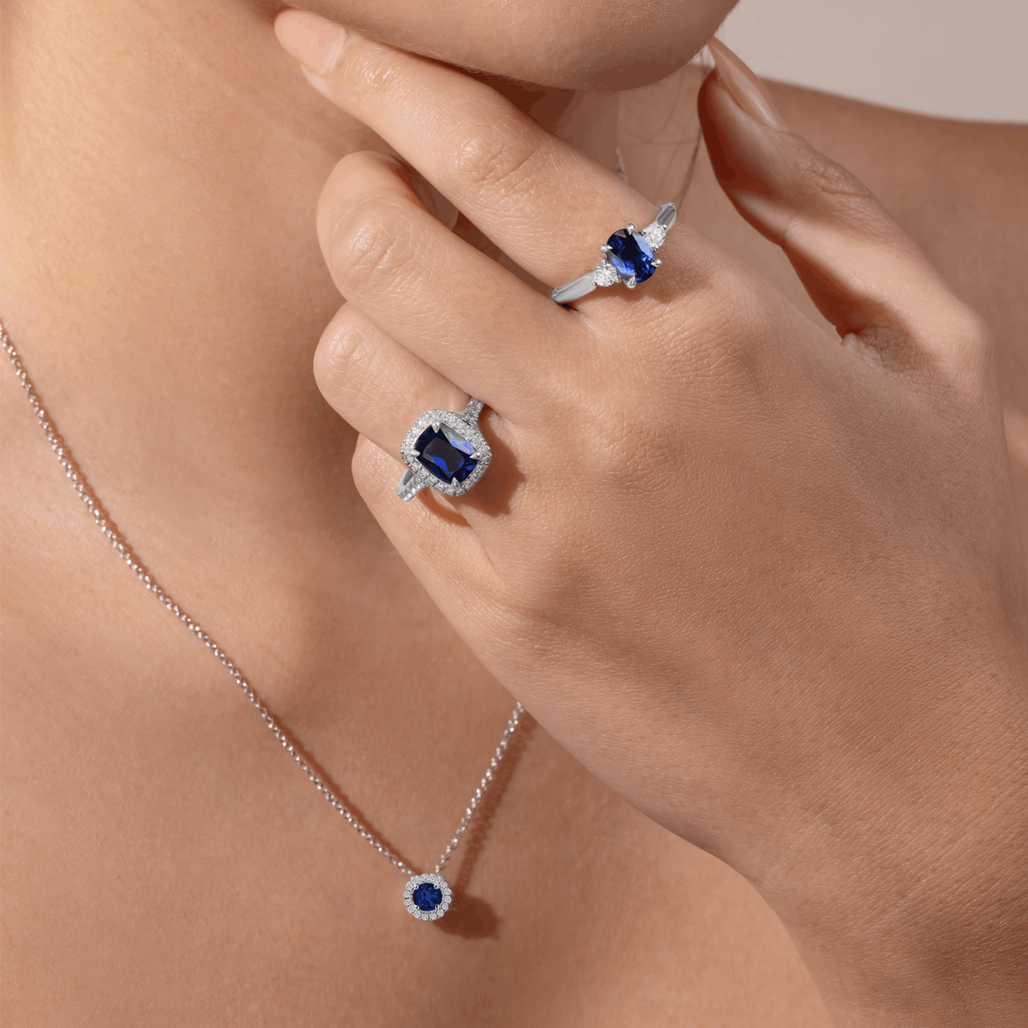 sapphire necklace and sapphire engagement rings on model