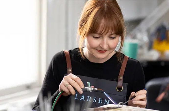 A Larsen Jeweller carefully creating a bespoke wedding ring out of white gold.