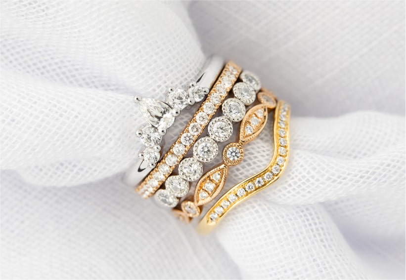 Stack of Unique Wedding Band Designs in White, Yellow and Rose Gold