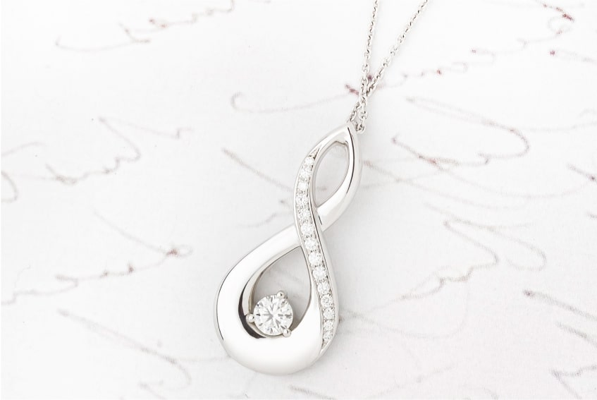 Twist Design Diamond Pendant with Grain Set Diamonds