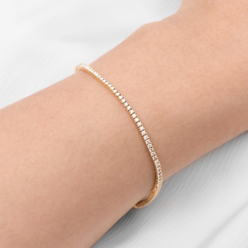 yellow gold diamond tennis bracelet on wrist