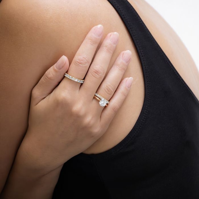 Hand wearing multiple popular wedding ring designs from Larsen Jewellery