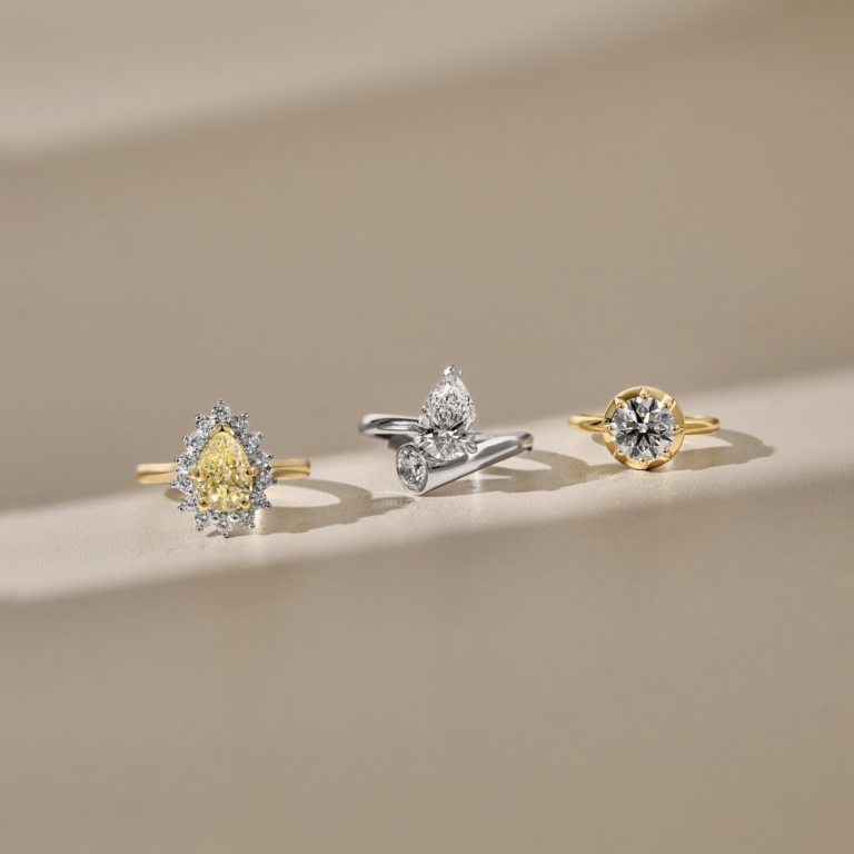 yellow diamond and a 18ct yellow gold band. platinum elongated double pearl diamond engagement ring. 18ct yellow gold band and a round cut diamond engagement ring