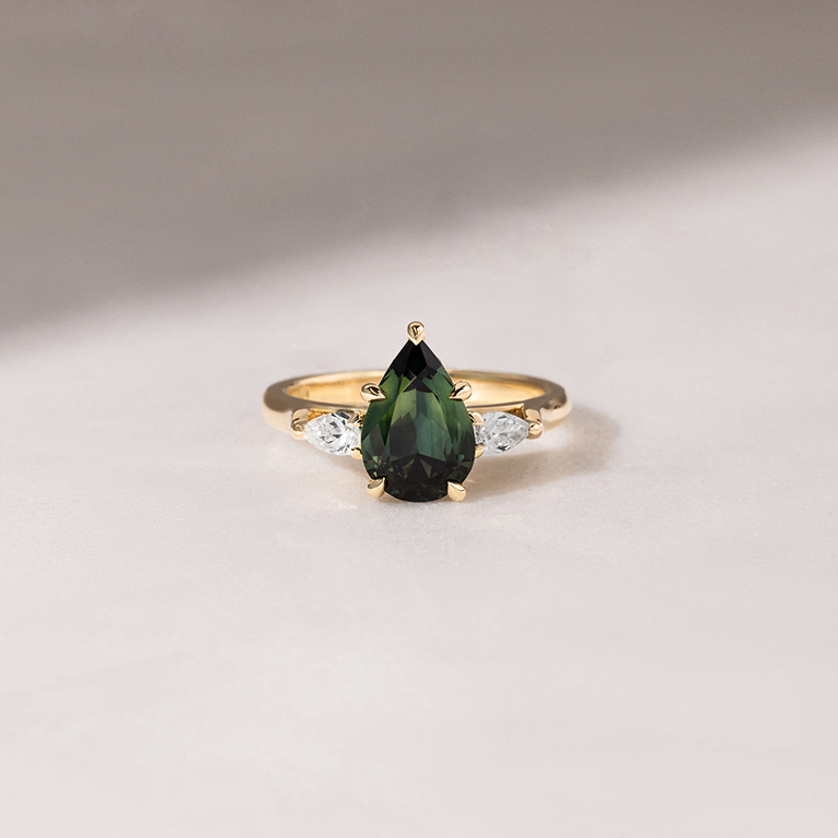 custom and bespoke engagement ring with a green sapphire centre stone and 2 diamond side stones at Larsen Jewellery in Sydney Melbourne and Brisbane
