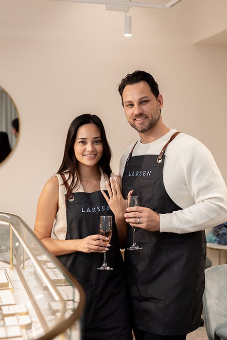 Couple showing off their hand made wedding rings after making and designing eachothers rings in the Larsen workshop