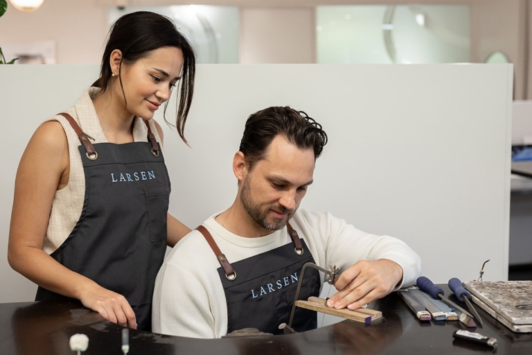Client learning to make a wedding ring for her fiance' during the make your own wedding rings experience at Larsen.