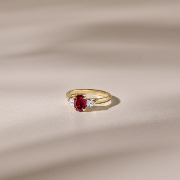 18ct Yellow Gold Band with 2 Round Diamond Side Stones and an Oval Ruby Gemstone