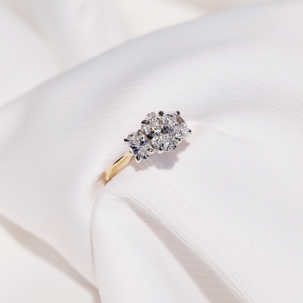 custom engagement ring oval trilogy diamond on a yellow gold band