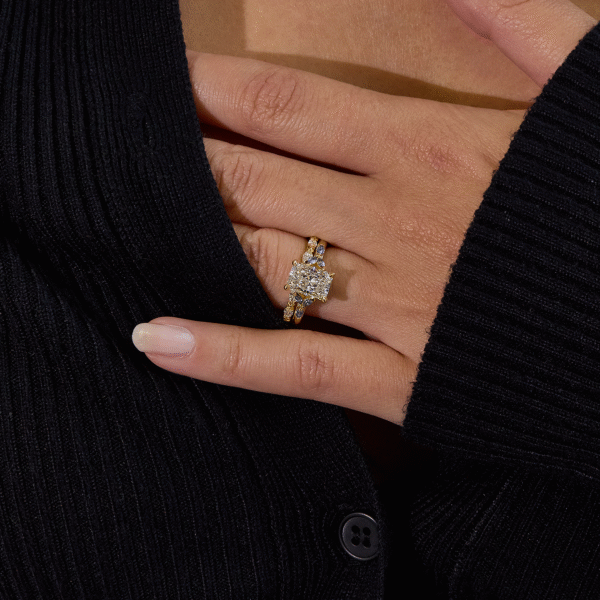 custom engagement ring - radiant cut diamond with diamond side stoens on yellow gold band