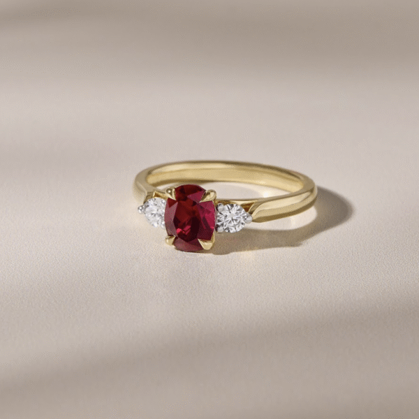 18ct Yellow Gold Band with 2 Round Diamond Side Stones and an Oval Ruby Gemstone
